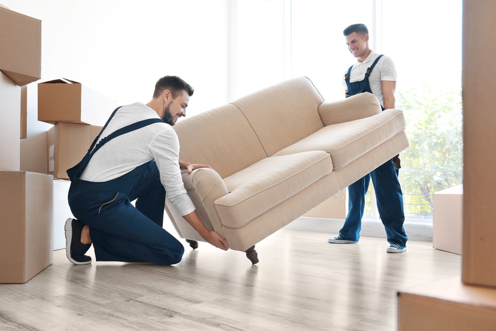 Removal workers carrying sofa